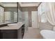Modern bathroom with double sink vanity, glass shower, and soaking tub at 23 Elliott St, Charleston, SC 29401