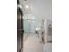 Modern bathroom featuring a glass shower, pedestal sink, hexagonal tile flooring, and updated fixtures at 23 Elliott St, Charleston, SC 29401