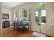 Sunlit breakfast nook with large windows offering views of the outdoor area at 23 Elliott St, Charleston, SC 29401