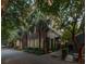 Brick house featuring mature palm trees and manicured landscaping, exuding timeless elegance and Southern charm at 23 Elliott St, Charleston, SC 29401