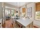 Bright kitchen with a large island featuring a stainless steel sink and breakfast bar at 23 Elliott St, Charleston, SC 29401