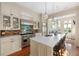 Open concept kitchen with stainless steel appliances, marble island, and beautiful tile backsplash at 23 Elliott St, Charleston, SC 29401