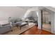 Attic living room with hardwood floors, sloped ceilings, and ample seating at 23 Elliott St, Charleston, SC 29401