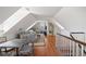 Attic living room with hardwood floors, seating area, and attached bathroom at 23 Elliott St, Charleston, SC 29401