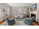 Bright living room featuring stylish furniture, hardwood floors, shutters, and a fireplace with decor at 23 Elliott St, Charleston, SC 29401