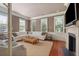 Bright living room features a fireplace, large windows, and comfortable white sectional sofa at 23 Elliott St, Charleston, SC 29401
