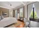 Main bedroom features a ceiling fan, balcony, and a decorative dresser with bench at 23 Elliott St, Charleston, SC 29401