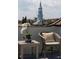 Balcony with seating, a table, an orchid, and views of the steeple and surrounding cityscape at 23 Elliott St, Charleston, SC 29401