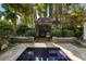 Secluded pool with landscaped surroundings provides a peaceful backyard retreat at 23 Elliott St, Charleston, SC 29401