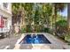 Inviting backyard pool area with a patio table and chairs, perfect for outdoor relaxation at 23 Elliott St, Charleston, SC 29401