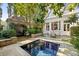 Pool area featuring lush landscaping and an outdoor dining set at 23 Elliott St, Charleston, SC 29401