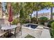 Inviting backyard pool area with a patio table and chairs surrounded by palm trees and lush greenery at 23 Elliott St, Charleston, SC 29401