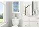 Clean and well-lit bathroom with a modern toilet, vanity, stylish mirror and window at 233 Denham St, Summerville, SC 29486