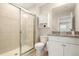 Bathroom includes glass shower, toilet, vanity with granite countertop, wall cabinet and tiled floor at 236 River Martin Ct, Summerville, SC 29483
