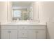 Bathroom features a double sink vanity with white cabinets, quartz countertop, and a large mirror at 236 River Martin Ct, Summerville, SC 29483