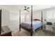 Bedroom boasts a four poster bed, a ceiling fan, and a desk next to shuttered windows at 236 River Martin Ct, Summerville, SC 29483