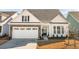 Charming home featuring stone accents, white siding, a two-car garage, and a beautifully landscaped front yard at 236 River Martin Ct, Summerville, SC 29483