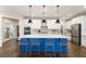 Modern kitchen features a blue kitchen island with bar seating and stainless steel appliances at 236 River Martin Ct, Summerville, SC 29483