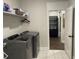 Modern laundry room with shelving above washer and dryer at 236 River Martin Ct, Summerville, SC 29483