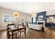 Bright living room with modern light fixture, fireplace, and view to the outside at 236 River Martin Ct, Summerville, SC 29483