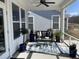 Covered porch features ceiling fan, seating on an area rug, and large potted plants at 236 River Martin Ct, Summerville, SC 29483