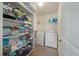 Functional laundry room equipped with washer, dryer, and ample shelving for storage solutions at 243 Clayburne Dr, Goose Creek, SC 29445