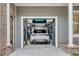 Luxury home garage featuring car lift with two sports cars: a white SUV and a green classic car at 25 Duany Rd, Mount Pleasant, SC 29464