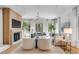 Bright living room with modern light fixture, neutral furniture, fireplace and multiple windows at 25 Duany Rd, Mount Pleasant, SC 29464