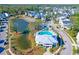Aerial view showcases the community pool, amenity center, pond, and neighborhood homes at 2613 Hatch Dr, Johns Island, SC 29455