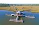 Aerial view showcasing a covered dock with boat access and serene waterways in a picturesque coastal setting at 2613 Hatch Dr, Johns Island, SC 29455