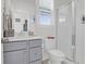Neat and clean bathroom featuring shower with glass doors, toilet, and gray cabinets at 2613 Hatch Dr, Johns Island, SC 29455