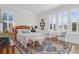 Cozy bedroom with a rattan headboard, windows with shutters, an area rug, and comfortable seating at 2613 Hatch Dr, Johns Island, SC 29455