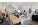Bright, open dining room with a large wood table, elegant chandelier, and access to other living spaces at 2613 Hatch Dr, Johns Island, SC 29455