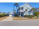 Charming two-story home boasts a welcoming porch and an attached garage with beautifully landscaped front yard at 2613 Hatch Dr, Johns Island, SC 29455