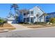 Charming two-story home boasts a welcoming porch and an attached garage with beautifully landscaped front yard at 2613 Hatch Dr, Johns Island, SC 29455