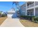 Exterior showcasing a modern home and detached garage accessible via a concrete driveway and manicured lawn at 2613 Hatch Dr, Johns Island, SC 29455