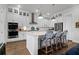 Bright, open kitchen with shaker cabinets, stainless appliances, large island with seating, and pendant lights at 2613 Hatch Dr, Johns Island, SC 29455