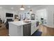 Bright, open kitchen with island, stainless steel appliances, farmhouse sink, and access to outdoor space at 2613 Hatch Dr, Johns Island, SC 29455