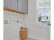 Bright laundry room features gray cabinets for storage space and a wicker laundry basket at 2613 Hatch Dr, Johns Island, SC 29455