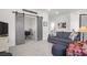Cozy living room with a plush couch, sliding barn doors, and decorative accents creating a warm atmosphere at 2613 Hatch Dr, Johns Island, SC 29455