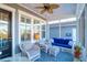 Relaxing porch with cozy seating, ceiling fan, blue accents, and natural light at 2613 Hatch Dr, Johns Island, SC 29455