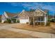Charming home with stone and siding exterior, two-car garage, and cozy front porch at 3034 Cross Vine Ln, Summerville, SC 29483