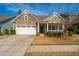 Charming home with stone and siding exterior, two-car garage, and cozy front porch at 3034 Cross Vine Ln, Summerville, SC 29483