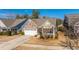 Charming home with stone and siding exterior, two-car garage, and cozy front porch at 3034 Cross Vine Ln, Summerville, SC 29483