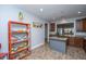 Open-concept kitchen features a center island, granite countertops, and an orange decorative shelving unit at 3034 Cross Vine Ln, Summerville, SC 29483