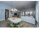 Open-concept living and dining area with wood-look tile floors, modern lighting, and comfortable seating at 3034 Cross Vine Ln, Summerville, SC 29483