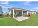 The backyard features a screened patio with grills and a beautiful lawn for relaxing and entertaining at 306 Autumn Azalea Way, Summerville, SC 29486
