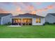 A spacious backyard featuring a patio, grill, and screened-in porch, perfect for outdoor enjoyment at 306 Autumn Azalea Way, Summerville, SC 29486