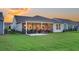 A well-maintained backyard featuring a patio, grill, and screened-in porch at 306 Autumn Azalea Way, Summerville, SC 29486