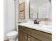 This bathroom shows a sink with gray cabinets and a view into the shower with a white curtain at 306 Autumn Azalea Way, Summerville, SC 29486